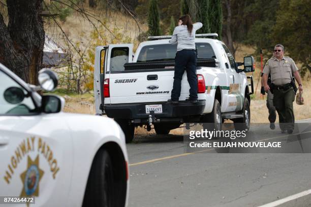 Crime scene photographer takes photos of a Sheriff's vehicle that was involved in a shooting on November 14 in Rancho Tehama, California. Four people...