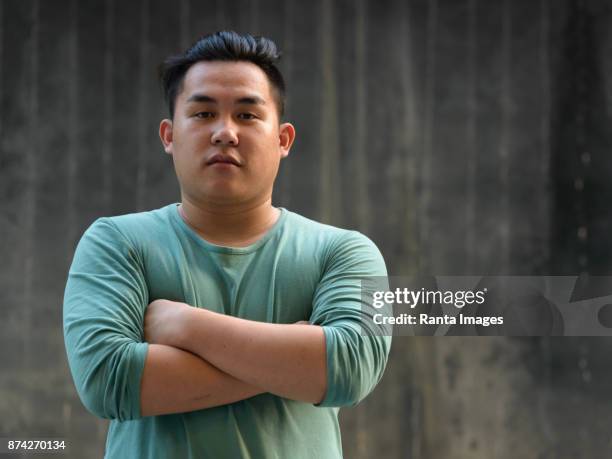young handsome asian man enjoying life in the city of bangkok, thailand - fat asian man stock pictures, royalty-free photos & images