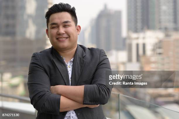 young handsome asian businessman enjoying life in the city of bangkok, thailand - fat asian man stock pictures, royalty-free photos & images