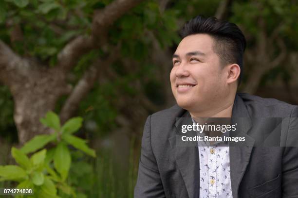 young handsome asian businessman enjoying life in the city of bangkok, thailand - fat asian man stock pictures, royalty-free photos & images