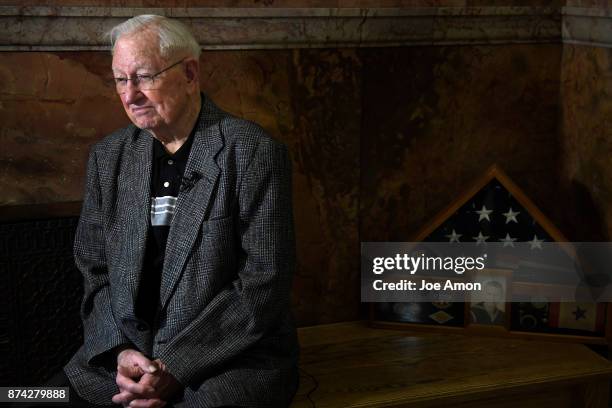 Veteran Charles "Ken" Farley 90, sits for an interview with a shadow box containing three medals earned but never received, presented to him by Gov....