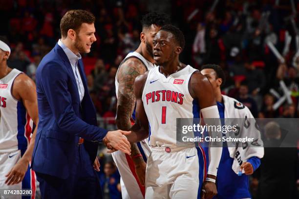 Reggie Jackson of the Detroit Pistons gives high five to Jon Leuer of the Detroit Pistons on November 10, 2017 at Little Caesars Arena in Auburn...