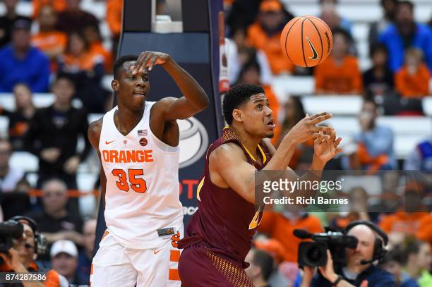 Bourama Sidibe of the Syracuse Orange and Gavin Kensmil of the Iona Gaels react to a loose ball during the second half at the Carrier Dome on...