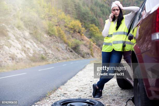 young female driver wearing a high visibility vest - service level high stock pictures, royalty-free photos & images