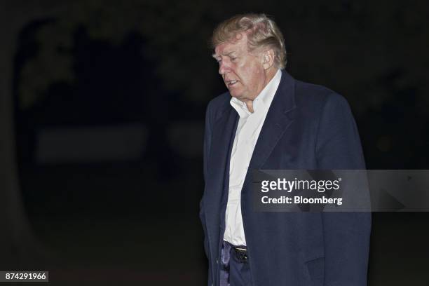President Donald Trump walks towards the White House on the South Lawn after returning from an 11-day Asia trip in Washington, D.C., U.S., on...