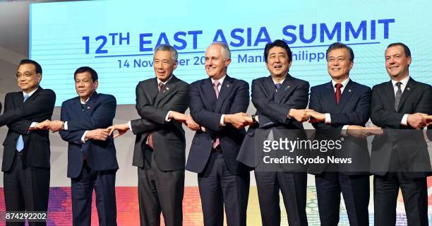 Leaders from the members of the East Asia Summit pose for photos in Manila on Nov. 14, 2017. The leaders condemned North Korea's development of...