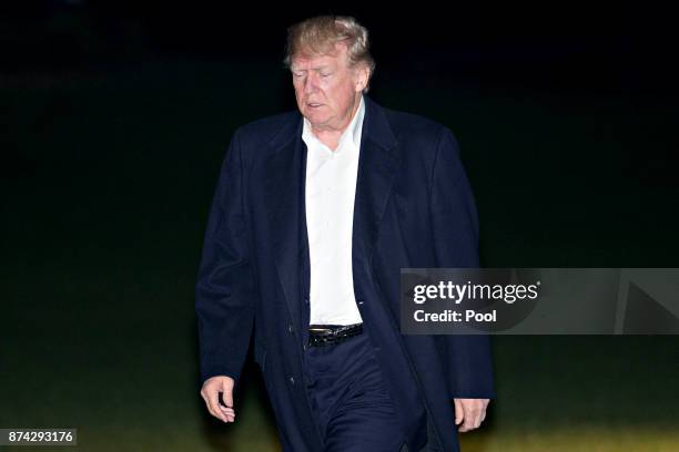 President Donald Trump walks on the South Lawn of the White House after returning from an 11-day Asia trip November 14, 2017 in Washington, D.C....