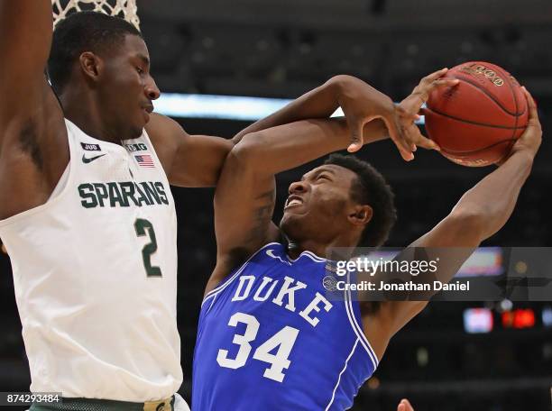 Wendell Carter Jr of the Duke Blue Devils is fouled by Jaren Jackson Jr. #2 of the Michigan State Spartans during the State Farm Champions Classic at...