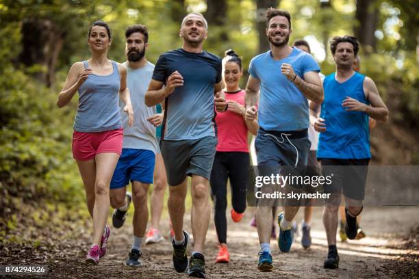 large group of happy athletes running a marathon race in nature. - large group of people running stock pictures, royalty-free photos & images