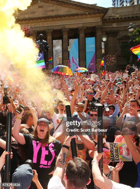 People in the crowd celebrate as the result is announced during the Official Melbourne Postal Survey Result Announcement at the State Library of...