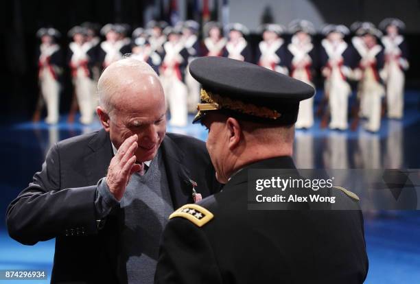 Sen. John McCain salutes to Army Chief of Staff Gen. Mark A. Milley after he was presented with the Outstanding Civilian Service Medal during a...