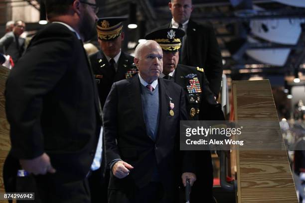 Sen. John McCain , accompanied by Army Chief of Staff Gen. Mark A. Milley , after he was presented with the Outstanding Civilian Service Medal during...