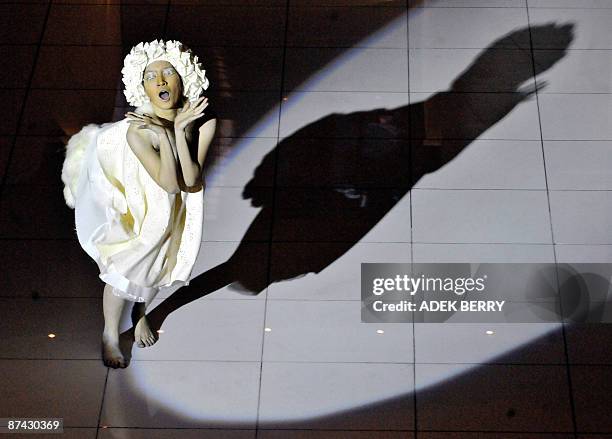 An Indonesian dancer performs "La Femme Paysage, vision de Paris à Java" or 'Woman in the scene, vision from Paris to Java' during a fashion show by...