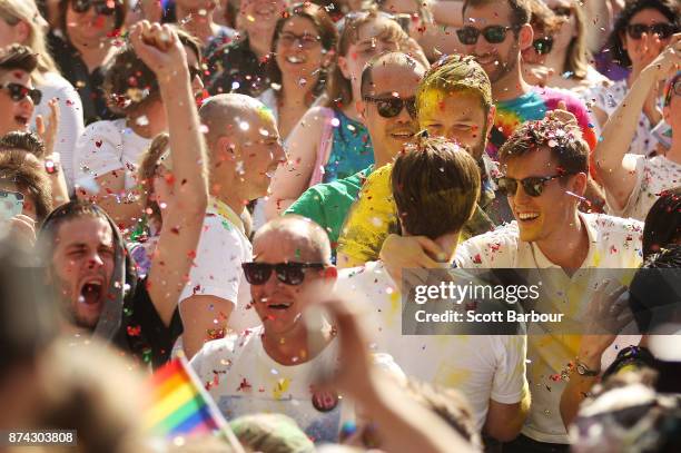 People in the crowd celebrate as the result is announced during the Official Melbourne Postal Survey Result Announcement at the State Library of...