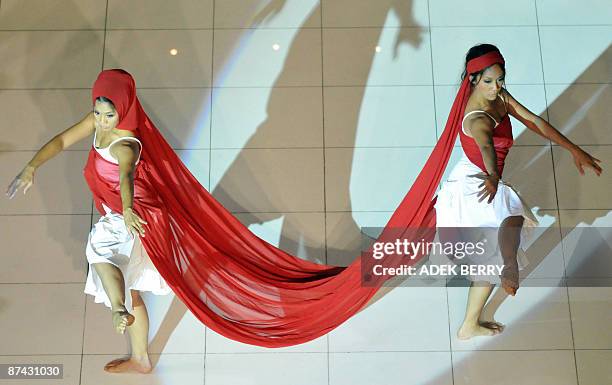 Indonesian dancers perform "La Femme Paysage, vision de Paris à Java" or 'Woman in the scene, vision from Paris to Java' during a fashion show by...