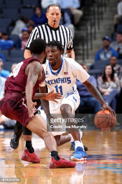 Malik Rhodes of the Memphis Tigers dribbles the ball up court against Anthony Black of the Little Rock Trojans on November 14, 2017 at FedExForum in...