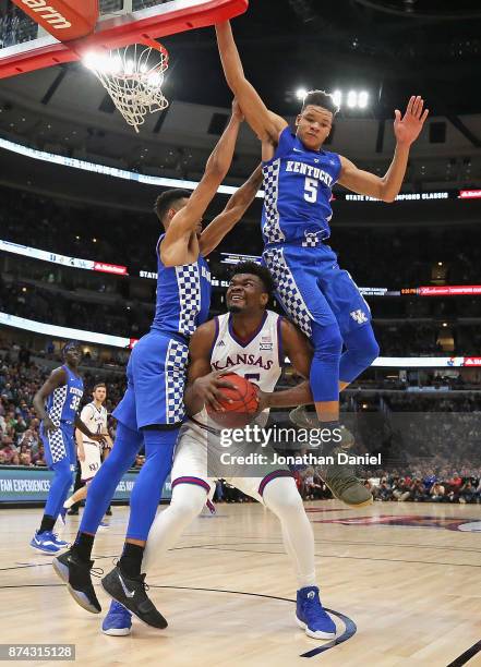 Udoka Azubuike of the Kansas Jayhawks is fouled as he tries to shoot between Sacha Killeya-Jones and Kevin Knox of the Kentucky Wildcats during the...