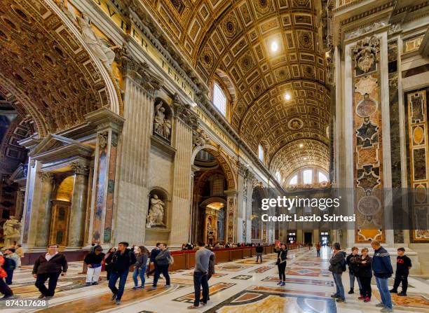 The St. Peter's basilica is seen from inside on November 1, 2017 in Vatican City, Vatican. Thousands of people visit every day the largest christian...