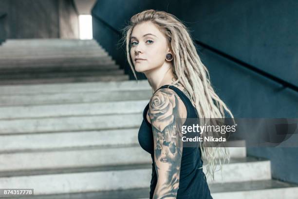 young tattooed womenwalking up urban staircase - rastafarian stock pictures, royalty-free photos & images