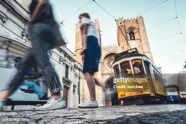 traffic around lisbon cathedral - lisbon tram stock pictures, royalty-free photos & images