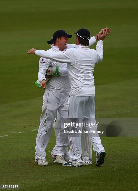 Andrew Strauss of England is congratulated by Graeme Swann of England after he caught out Lendl Simmons of West Indies off the bowling of James...