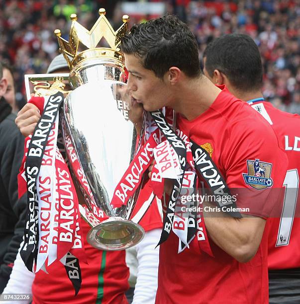 Cristiano Ronaldo of Manchester United celebrates with the Premier League trophy after the Barclays Premier League match between Manchester United...