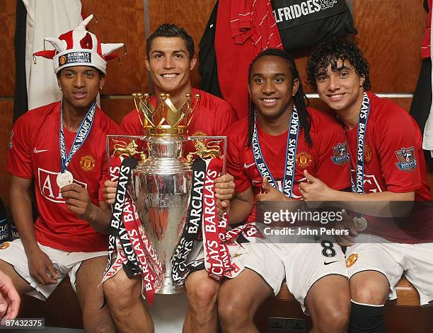 Nani, Cristiano Ronaldo, Anderson and Rafael Da Silva of Manchester United celebrate with the Premier League trophy in the dressing room after the...