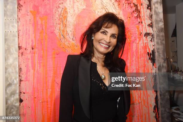 Emperatriz Rincones poses with a work of Chayan Khoi during 'La Femme dans Le Siecle' Exhibition and Award Ceremony Cocktail at Galerie FRM on...