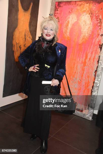 Armande Altai poses with works of Chayan Khoi during 'La Femme dans Le Siecle' Exhibition and Award Ceremony Cocktail at Galerie FRM on November 14,...