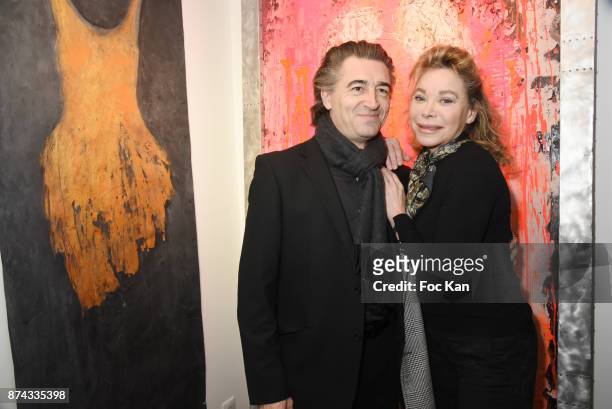 Jean Pierre Jacquin and Grace de Capitani pose with works of Chayan Khoi during 'La Femme dans Le Siecle' Exhibition and Award Ceremony Cocktail at...