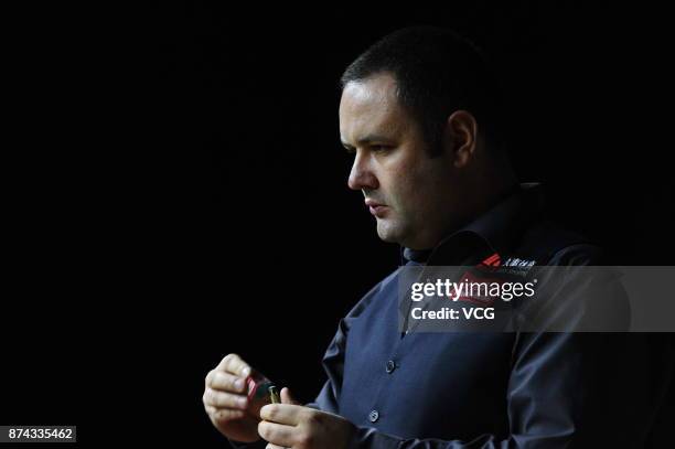 Stephen Maguire of Scotland chalks the cue during the first round match against Rory McLeod of England on day two of 2017 Shanghai Masters at...