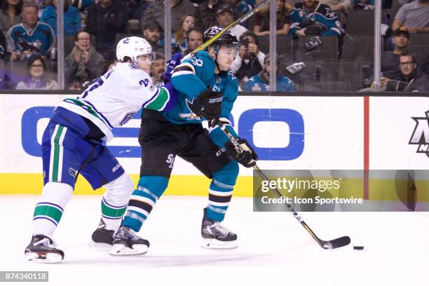 Vancouver Canucks defenseman Ben Hutton defends San Jose Sharks center Chris Tierney during the NHL game between the San Jose Sharks and the...