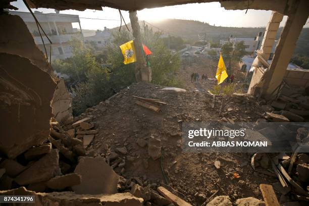 Local residents look at the remains of the house of Palestinian assailant Nemr al-Jamal after it was destroyed by Israeli troops in the West Bank...