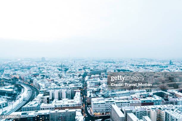 aerial view of snow covered rooftops at dusk, berlin, germany - berlin winter stock pictures, royalty-free photos & images