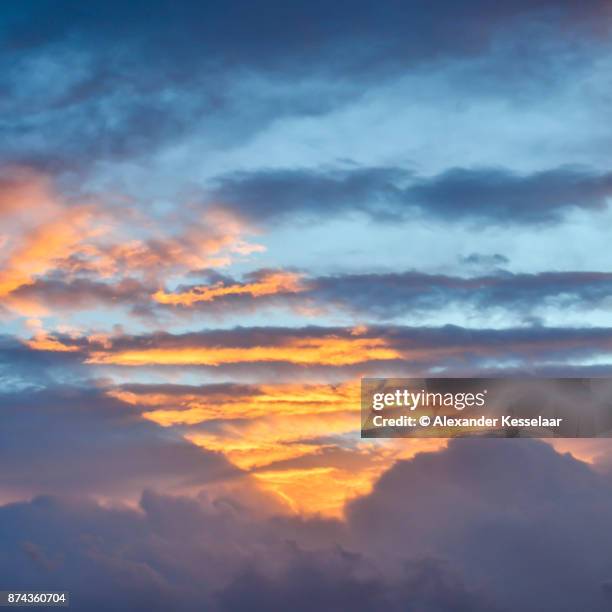 clouds at sunset - alexander kesselaar stock-fotos und bilder