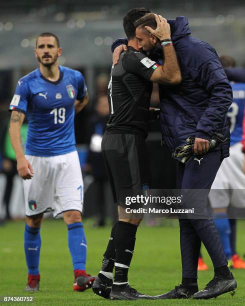 Gianluigi Buffon of Italy embraces Gianluigi Donnarumma at the end of the FIFA 2018 World Cup Qualifier Play-Off: Second Leg between Italy and Sweden...