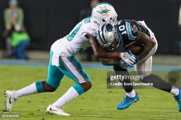Miami Dolphins cornerback Cordrea Tankersley hits Carolina Panthers wide receiver Curtis Samuel after the catch during the game on November 13, 2017...