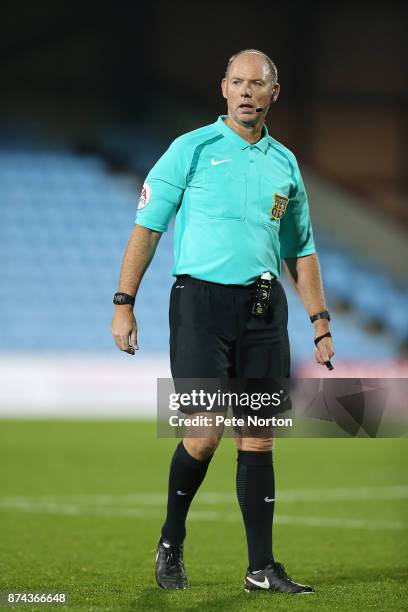 Referee Andy Haines looks on during the Emirates FA Cup First Round Replay match between Scunthorpe United and Northampton Town at Glanford Park on...