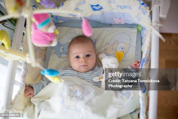 cute little baby boy, playing in crib in the afternoon - 生後1ヶ月 ストックフォトと画像