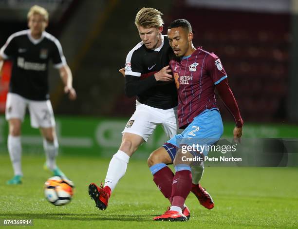 Jordan Clarke of Scunthorpe United plays the ball under pressure from George Smith of Northampton Town during the Emirates FA Cup First Round Replay...