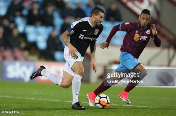 Marc Richards of Northampton Town moves forward with the ball during the Emirates FA Cup First Round Replay match between Scunthorpe United and...