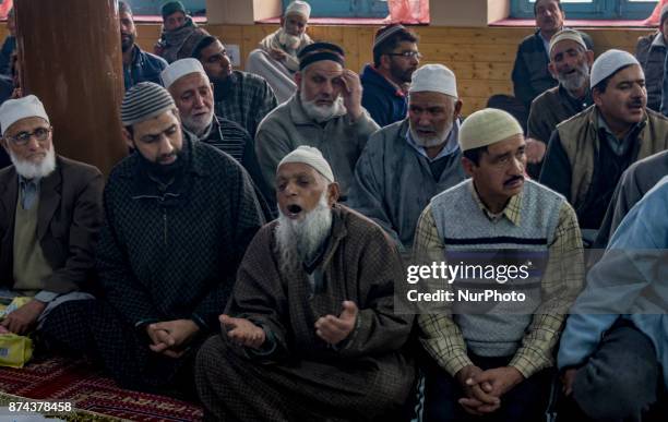 Kashmiri Muslim devotees pray at the shrine of the Sufi saint Sheikh Hamza Makhdoom during a festival on November 14, 2017 in Srinagar, the summer...