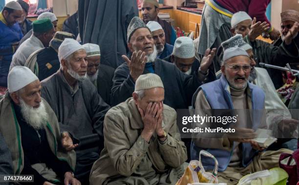 Kashmiri Muslim devotees pray at the shrine of the Sufi saint Sheikh Hamza Makhdoom during a festival on November 14, 2017 in Srinagar, the summer...