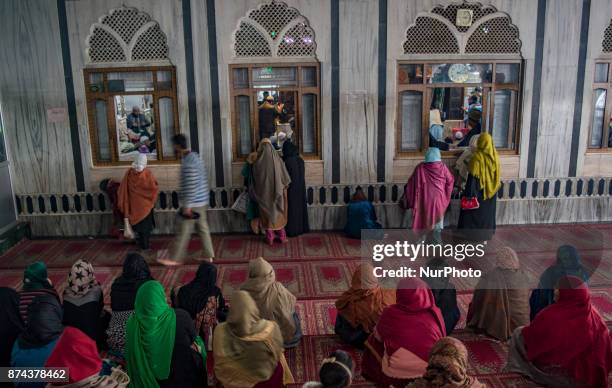 Kashmiri Muslim devotees pray at the shrine of the Sufi saint Sheikh Hamza Makhdoom during a festival on November 14, 2017 in Srinagar, the summer...