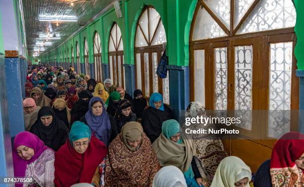 Kashmiri Muslim devotees pray at the shrine of the Sufi saint Sheikh Hamza Makhdoom during a festival on November 14, 2017 in Srinagar, the summer...