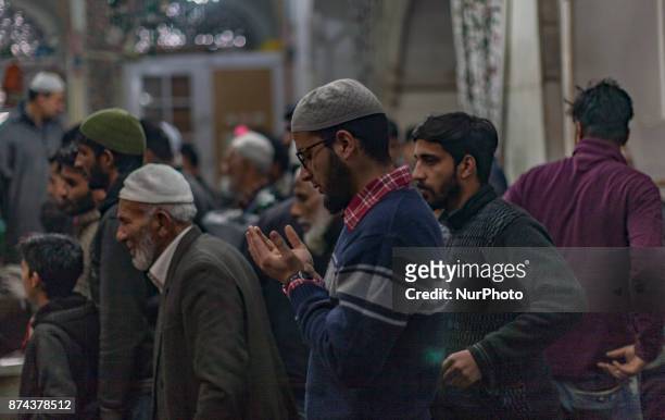 Kashmiri Muslim devotees pray at the shrine of the Sufi saint Sheikh Hamza Makhdoom during a festival on November 14, 2017 in Srinagar, the summer...