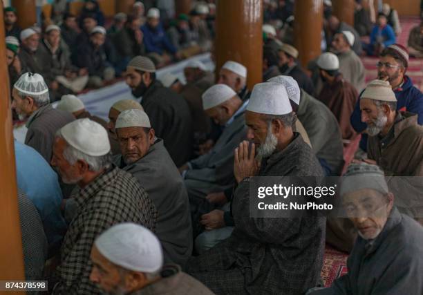 Kashmiri Muslim devotees pray at the shrine of the Sufi saint Sheikh Hamza Makhdoom during a festival on November 14, 2017 in Srinagar, the summer...