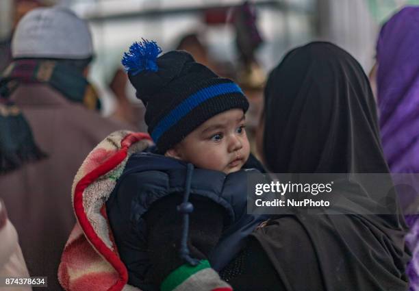 Kashmiri Muslim devotees pray at the shrine of the Sufi saint Sheikh Hamza Makhdoom during a festival on November 14, 2017 in Srinagar, the summer...