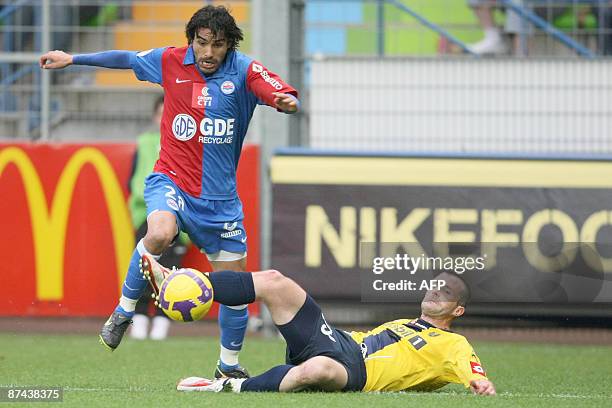Sochaux's Stephane Pichot vies with Caen's Juan Eduardo Eluchans during their French L1 football match on May 16 at the Michel-d'Ornano stadium in...