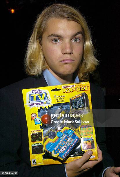 Emile Hirsch holding a Jakks Pacific, Inc. TV Game.